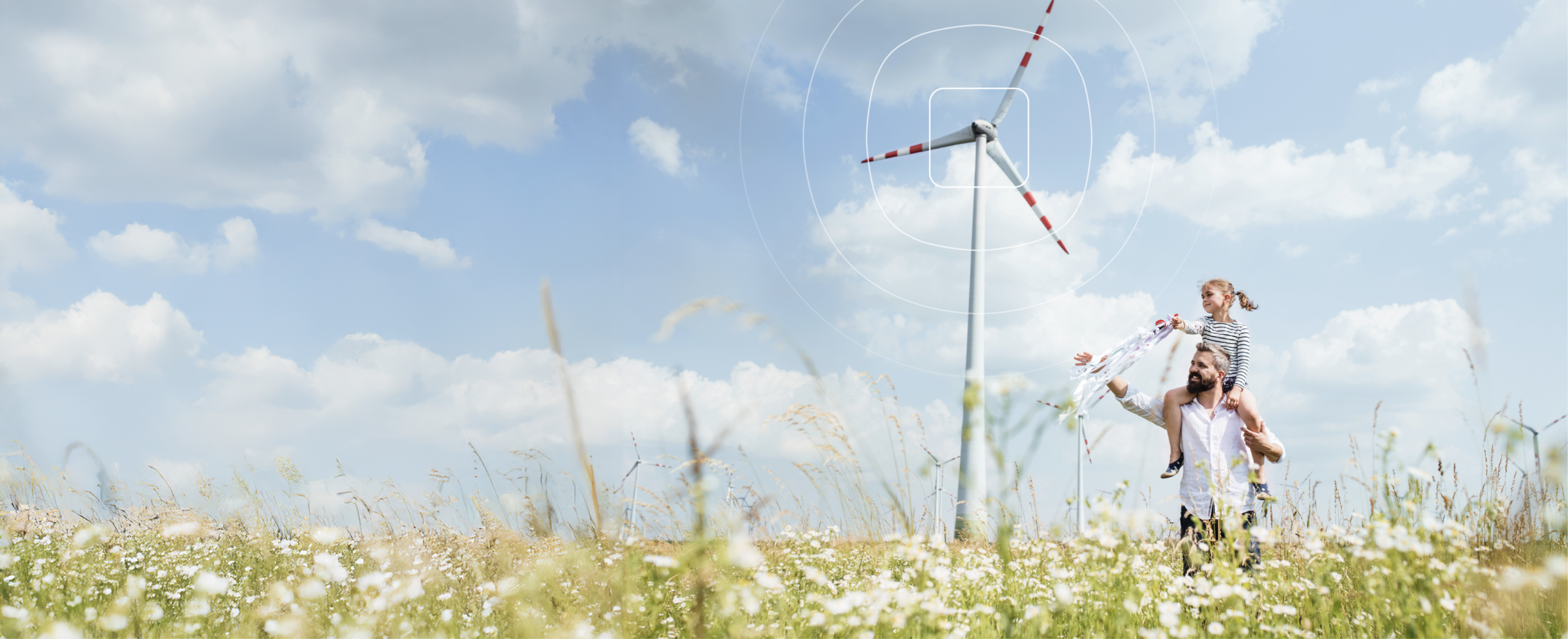 Father and child in a windmill field